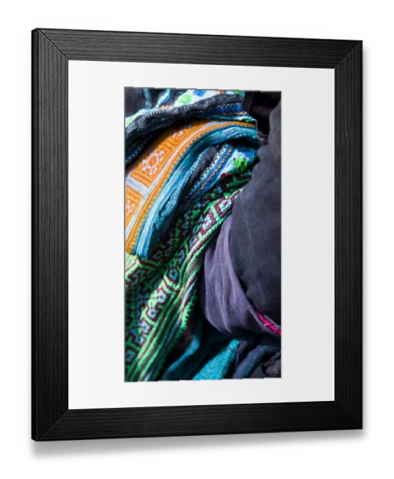 Framed Print : Vietnam, Northern Vietnam, Sapa. Hill tribe clothing and blankets hanging over the arm of a hill tribe woman trying to sell her wares