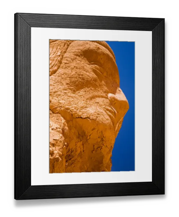 Framed Print : Chile, Atacama Desert, Plaza Quitor. Carved face in the stone wall of the Atacama Desert near the Plaza