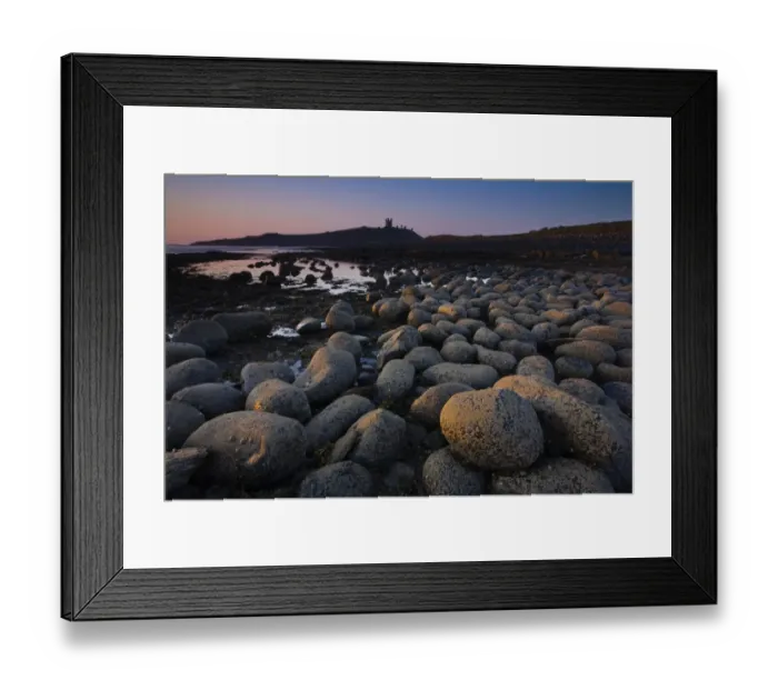 Framed Print : England, Northumberland, Embleton Bay. Weathered rocks dominate the low-tide shoreline of Embleton Bay