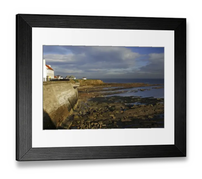 Framed Print : A sea wall built to defend the North Tyneside village of Cullercoats from the forces of the North Sea