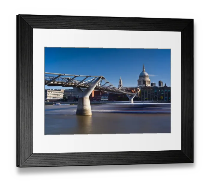 Framed Print : England, London, St Pauls Cathedral. A boat passes below the London Millennium Bridge which links the south bank of the Thames with St Pauls Cathedral Framed Print : England, London, St Pauls Cathedral. A boat passes below the London Millennium Bridge which links the south bank of the Thames with St Pauls Cathedral