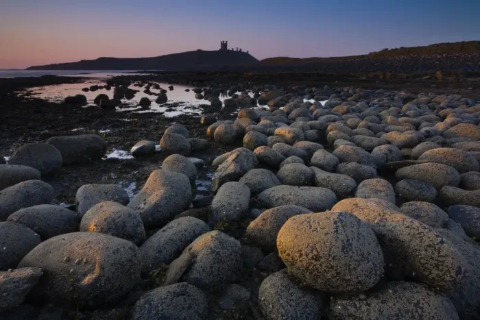 Framed Print : England, Northumberland, Embleton Bay. Weathered rocks dominate the low-tide shoreline of Embleton Bay
