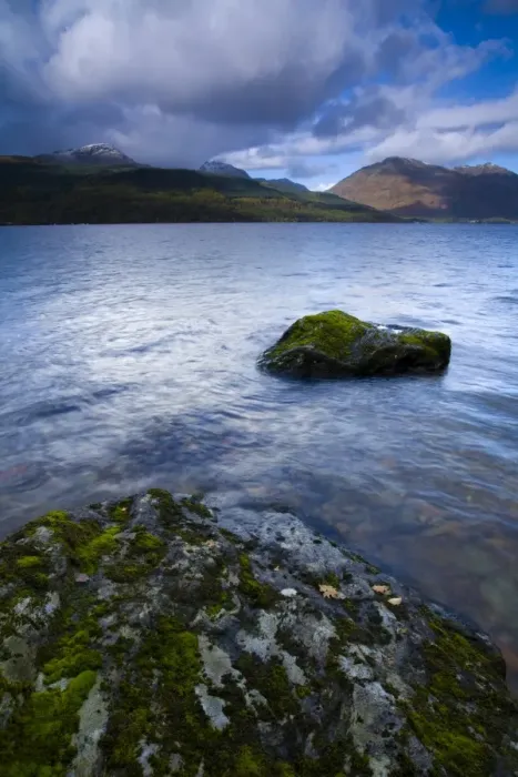 Framed Print : Scotland, Stirling, Loch Lomond and the Trossachs National Park. Moss covered boulders on Loch Lomond with mountains in Framed Print : Scotland, Stirling, Loch Lomond and the Trossachs National Park. Moss covered boulders on Loch Lomond with mountains in