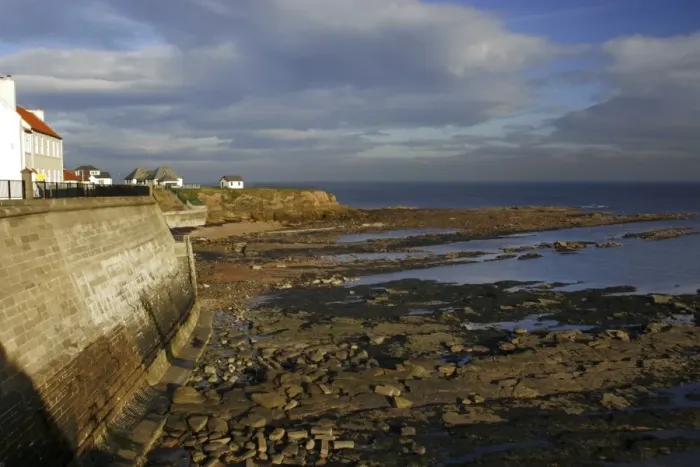 Framed Print : A sea wall built to defend the North Tyneside village of Cullercoats from the forces of the North Sea