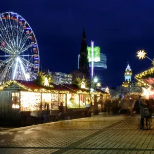Scotland, Edinburgh, Princes Street Christmas Market. A traditional European Christmas Market located along Princes Street with the Scotts Monument and Balmoral Clock Tower in view