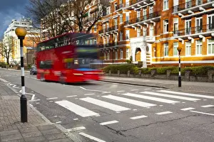 2012 Prints: England, London, Abbey Road. A red London bus approaches the famous pedestrian crossing at Abbey Road
