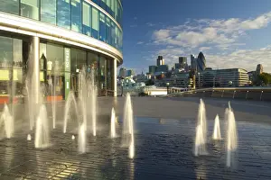 England, London, Southwark. Water fountains near the London City Hall and the More London develpoment, looking towards the financial district of the City of London