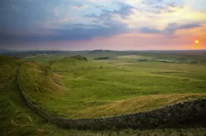 ENGLAND Northumberland Hadrians Wall Sunset behind the world heritage site of Hadrians Wall near the town of