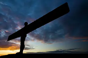The iconic Angel of the North statue silhouetted against an atmospheric sky
